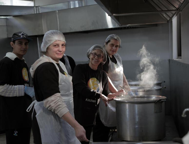 Three cooks at one of WCK's kitchens in Lebanon prepare meals for families impacted by conflict.