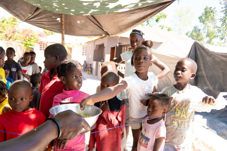 Children receive emergency food relief from WCK teams in Haiti.